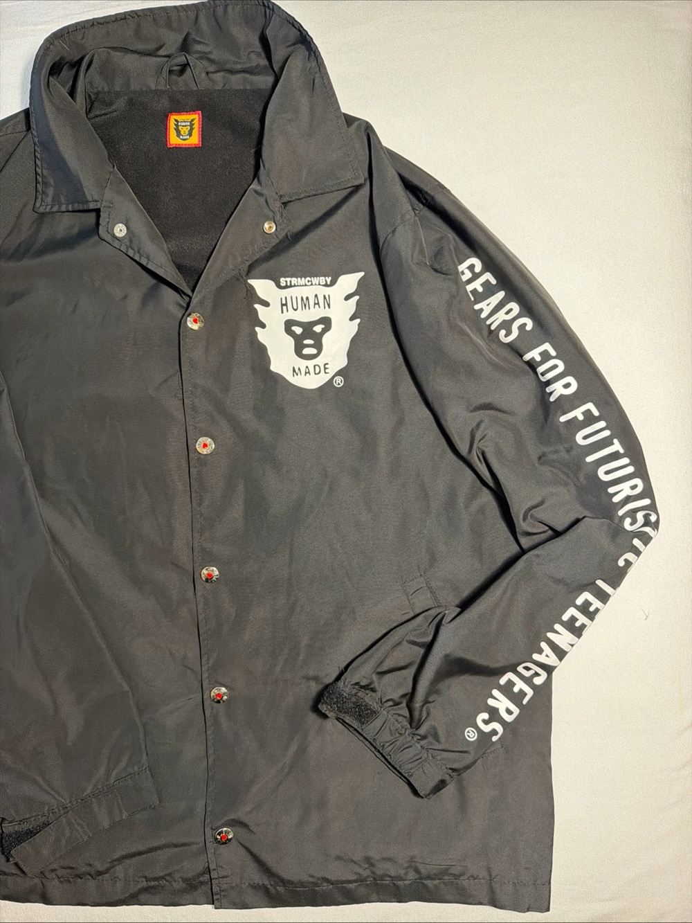 Human Made Black Coach Jacket with White Logo and Sleeve Text